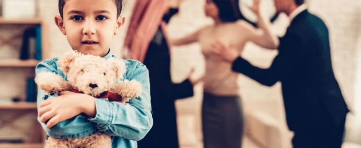 Family in Lawyer Office. Couple is Arab Husband, Wife and Son. Lawyer is Caucasian Man in Suit. Blur View of Parents is Have Conflict and Arguing. Boy is Holding Teddy Bear and Going Through.